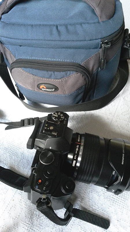 EM5 with 12-40 lens and small shoulder case.
