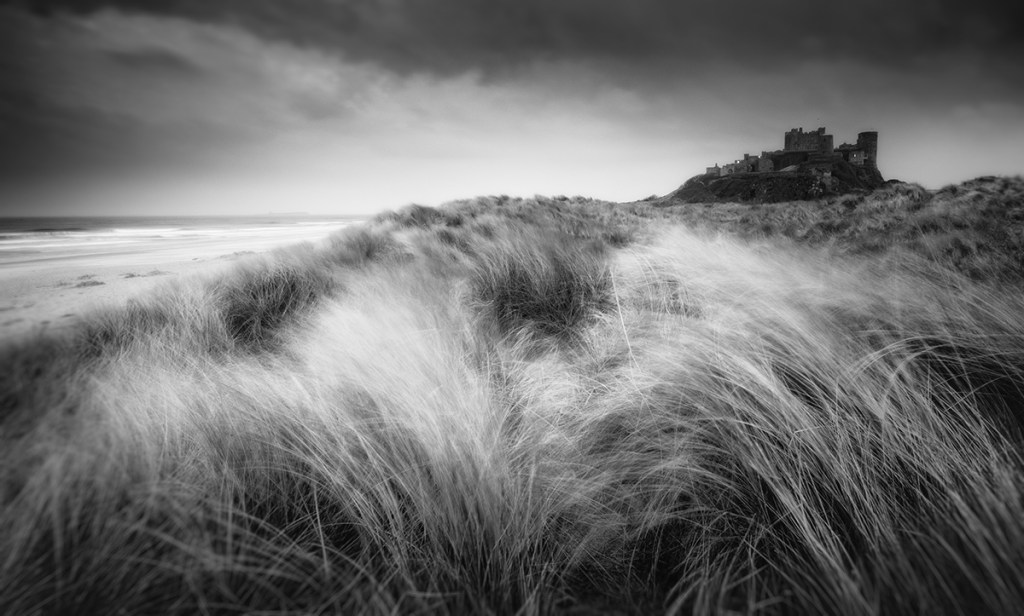 Bamburgh at sunset through the dunes